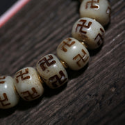 Detail view of Carved Symbol Bead Buddhist Bracelet with Green Accent (4 of 6)