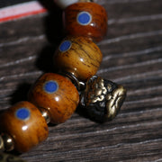 Detail view of Brown Inlaid Bead Tibetan Bracelet with Medallion Charm (3 of 6)