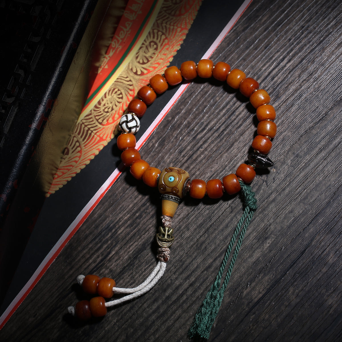 Detail view of Amber-Color Buddhist Bead Bracelet with Dzi Accent (3 of 6)