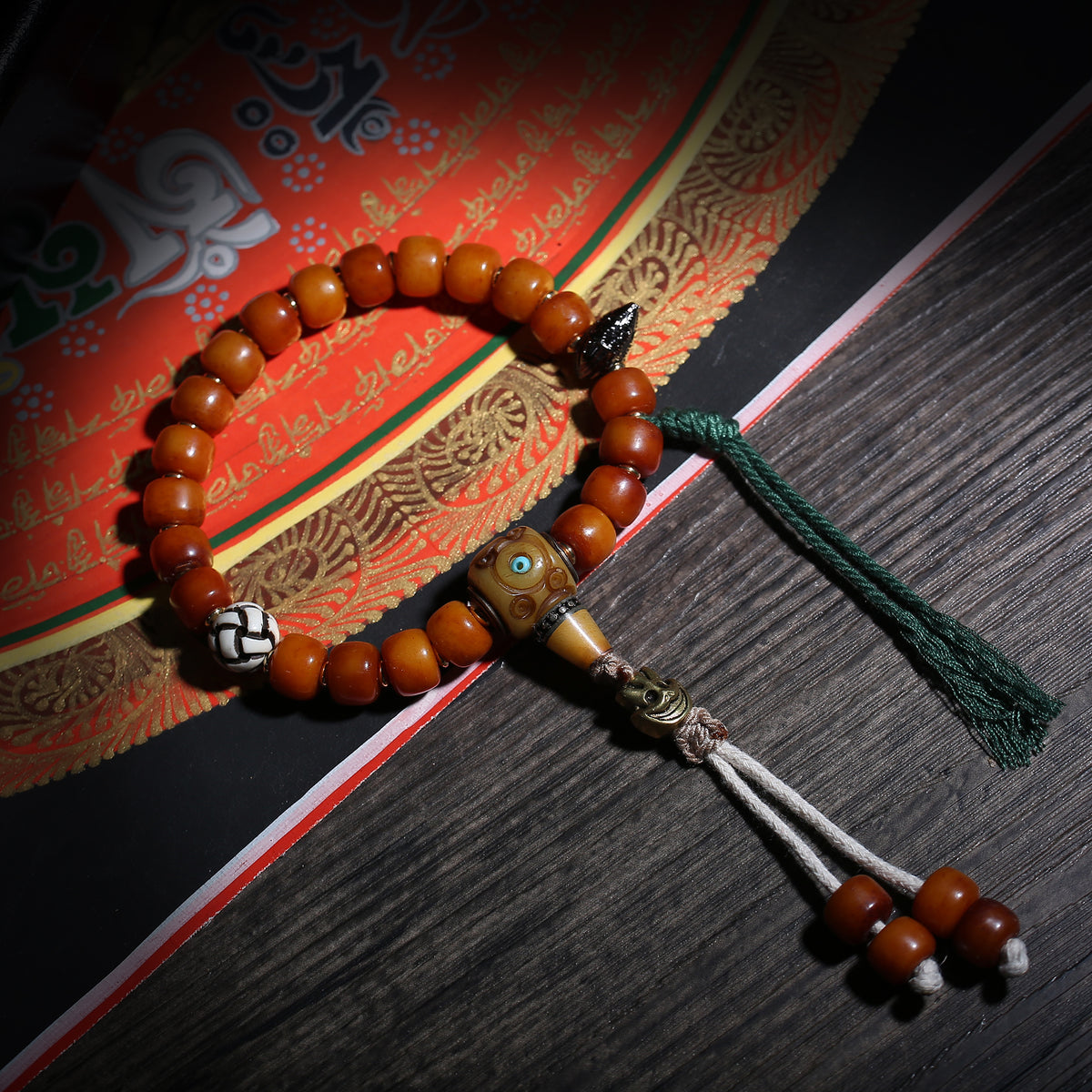 Detail view of Amber-Color Buddhist Bead Bracelet with Dzi Accent (4 of 6)