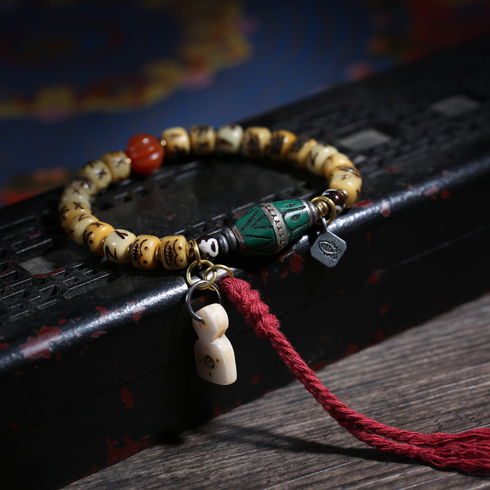 Carved Cream Bead Tibetan Bracelet with Green Accent