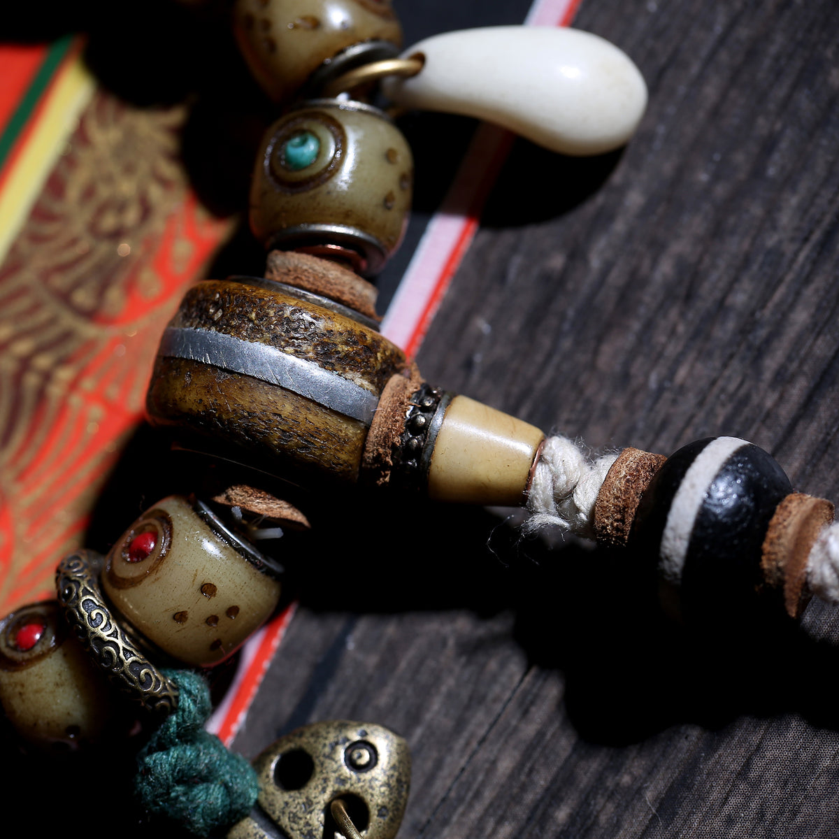 Detail view of Inlaid Barrel Bead Tibetan Bracelet with Tassel Charms (5 of 6)