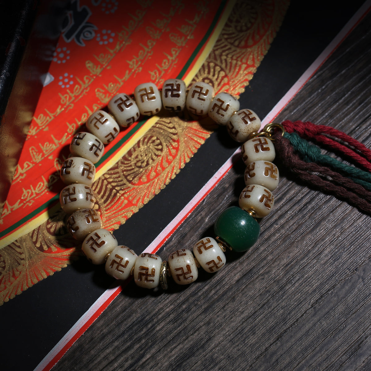 Detail view of Carved Symbol Bead Buddhist Bracelet with Green Accent (2 of 6)