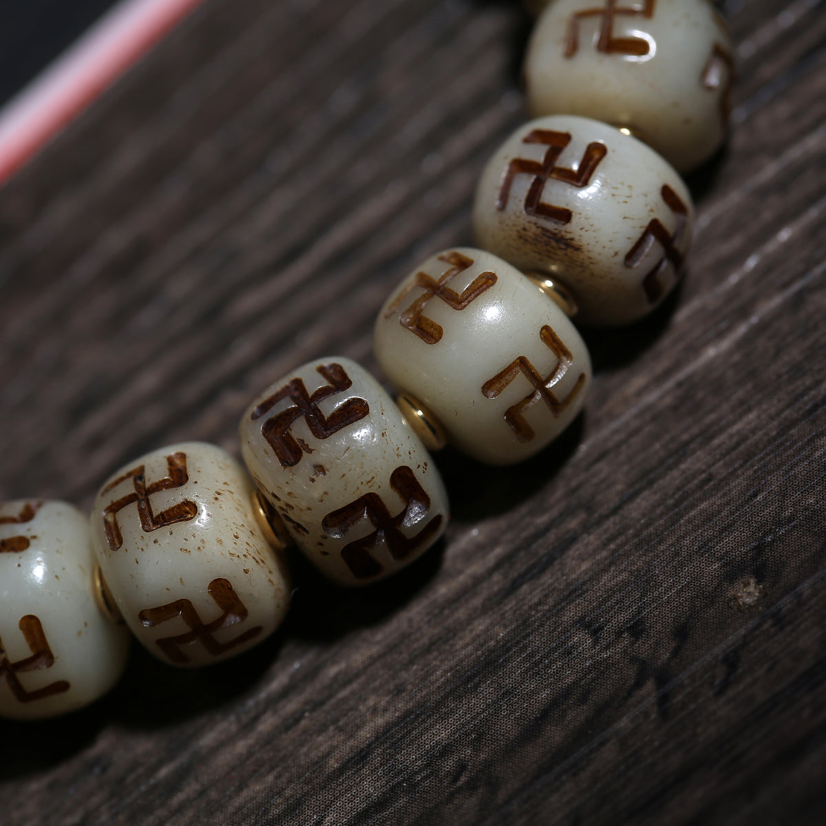 Detail view of Carved Symbol Bead Buddhist Bracelet with Green Accent (4 of 6)