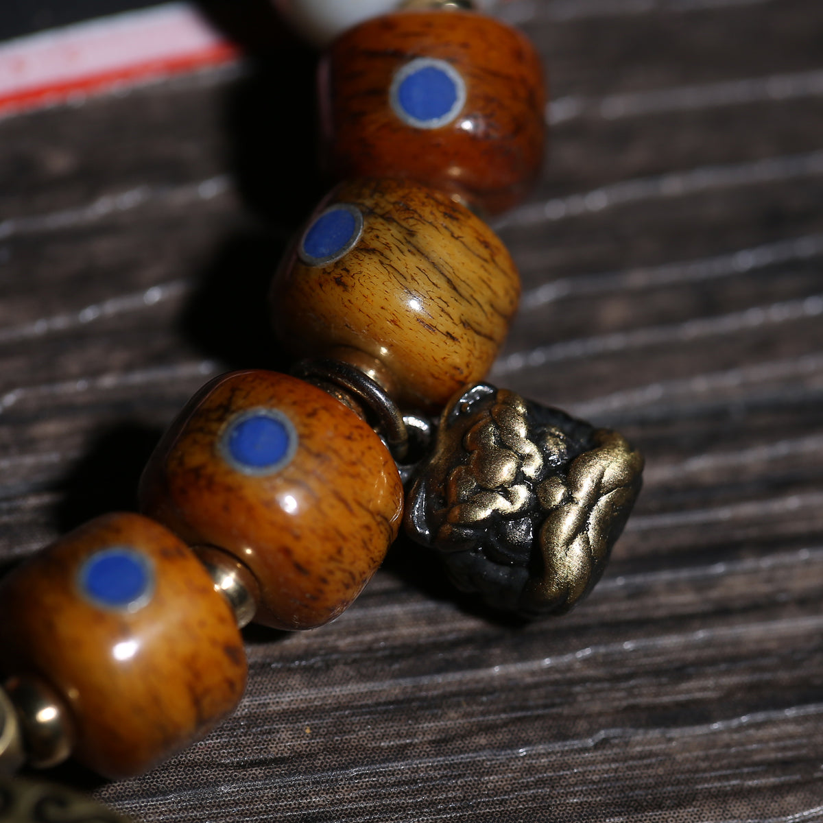 Detail view of Brown Inlaid Bead Tibetan Bracelet with Medallion Charm (3 of 6)