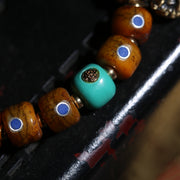 Detail view of Brown Inlaid Bead Tibetan Bracelet with Medallion Charm (4 of 6)
