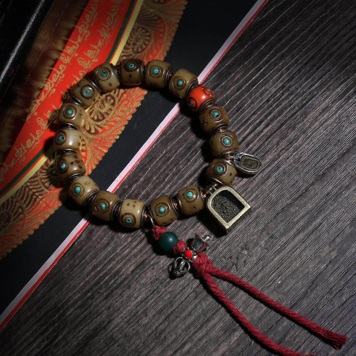 Detail view of Turquoise-Inlaid Buddhist Bracelet with Amulet Charms (2 of 6)