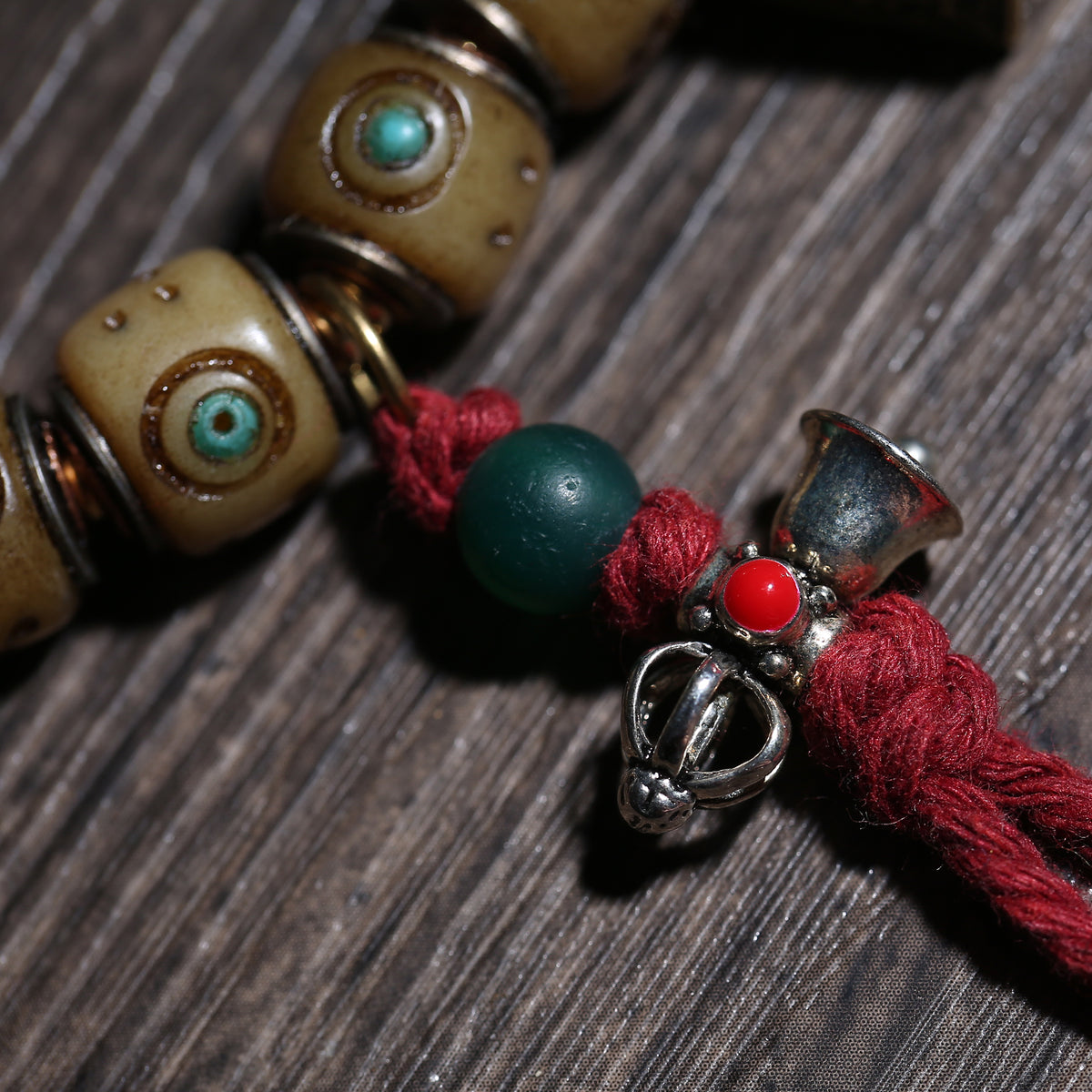 Detail view of Turquoise-Inlaid Buddhist Bracelet with Amulet Charms (4 of 6)