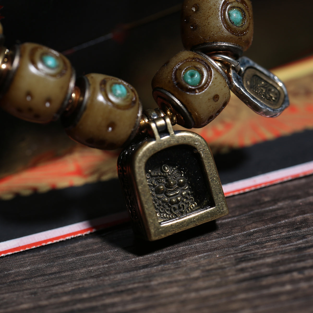 Detail view of Turquoise-Inlaid Buddhist Bracelet with Amulet Charms (5 of 6)