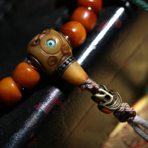 Detail view of Amber-Color Buddhist Bead Bracelet with Dzi Accent (2 of 6)
