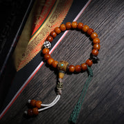 Detail view of Amber-Color Buddhist Bead Bracelet with Dzi Accent (3 of 6)