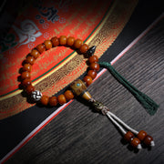 Detail view of Amber-Color Buddhist Bead Bracelet with Dzi Accent (4 of 6)