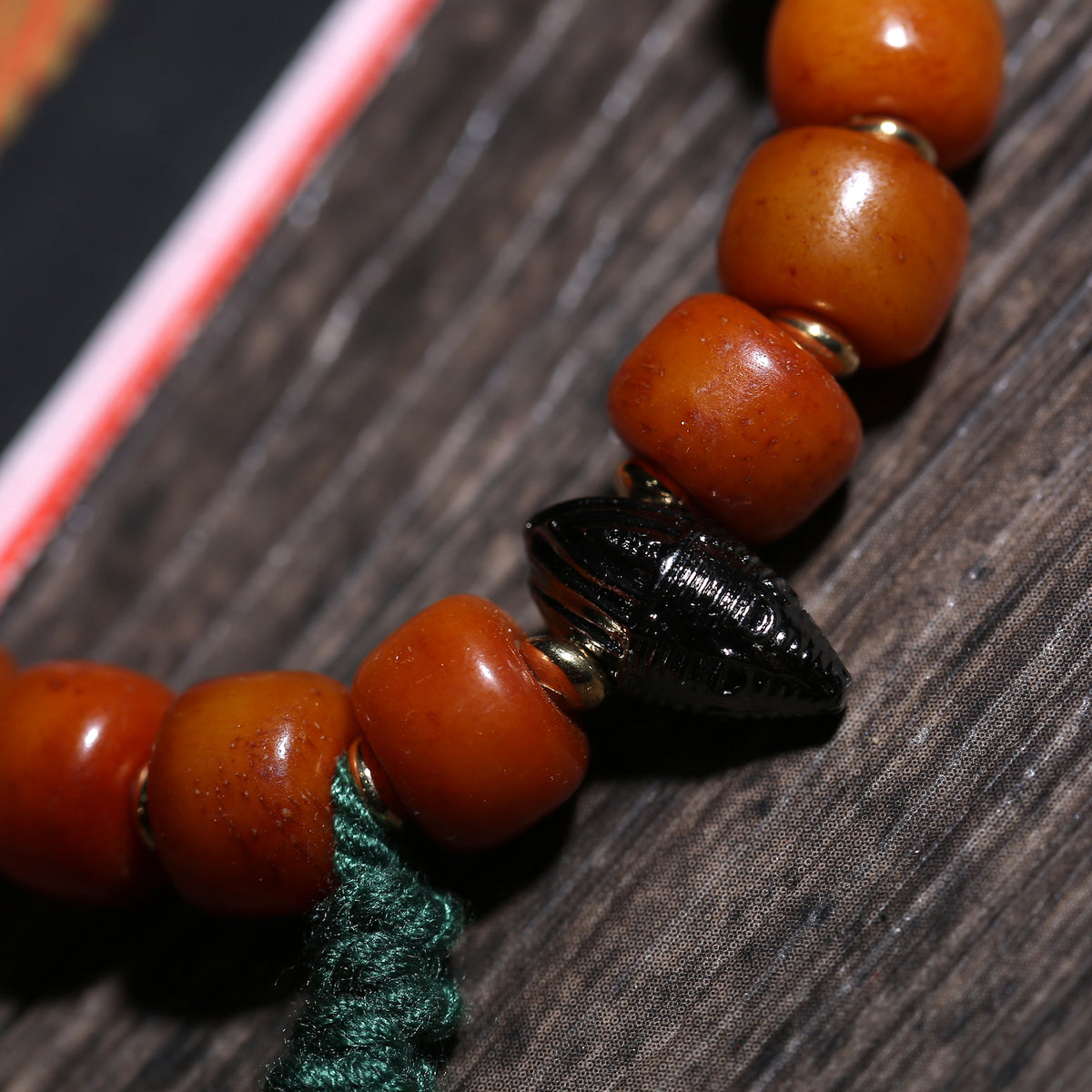 Detail view of Amber-Color Buddhist Bead Bracelet with Dzi Accent (5 of 6)