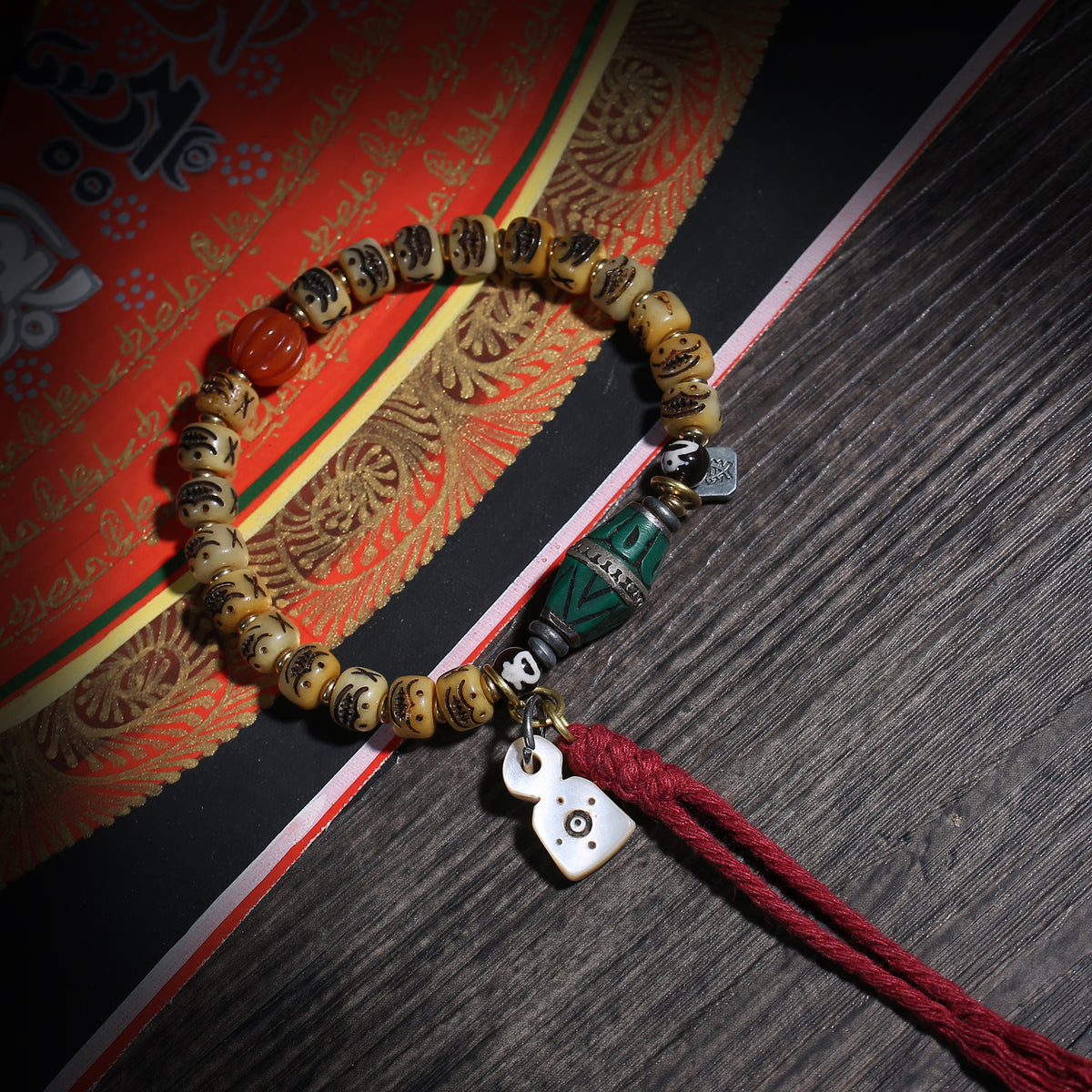 Detail view of Carved Cream Bead Tibetan Bracelet with Green Accent (4 of 6)
