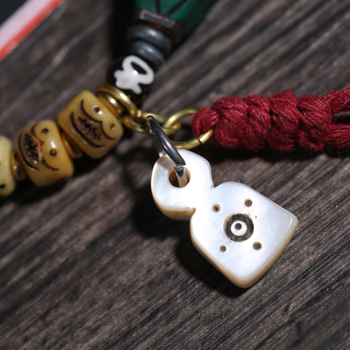 Detail view of Carved Cream Bead Tibetan Bracelet with Green Accent (5 of 6)