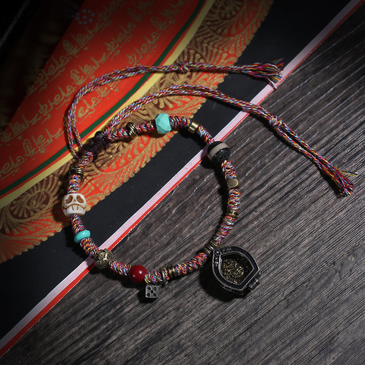 Detail view of Multicolor Cord Buddhist Bracelet with Amulet Charm (2 of 6)
