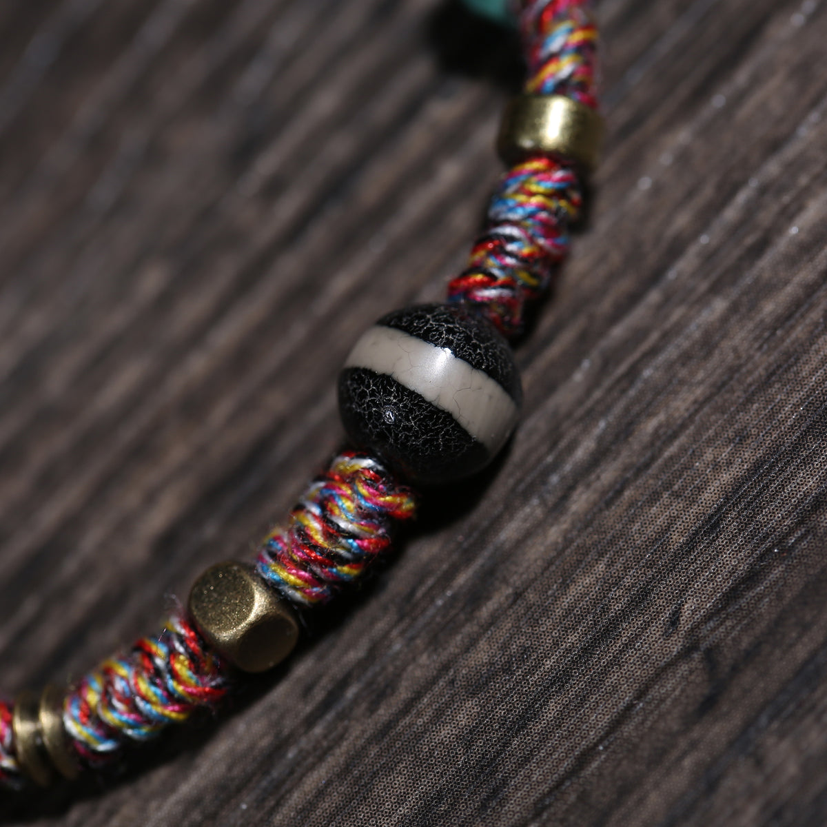 Detail view of Multicolor Cord Buddhist Bracelet with Amulet Charm (3 of 6)