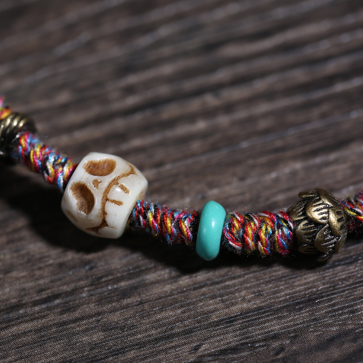 Detail view of Multicolor Cord Buddhist Bracelet with Amulet Charm (4 of 6)