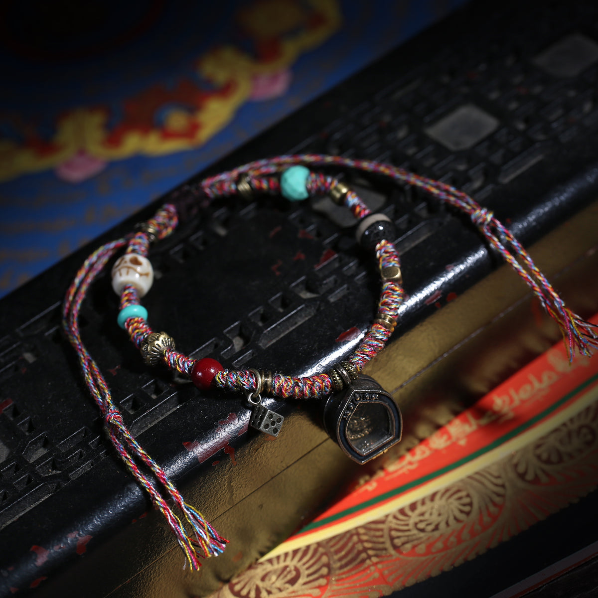 Detail view of Multicolor Cord Buddhist Bracelet with Amulet Charm (5 of 6)